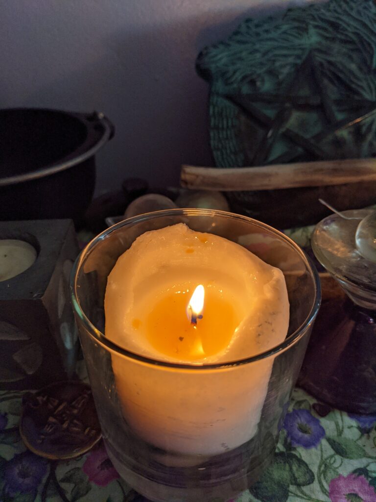 Lit candle with essential oils cast a spell
