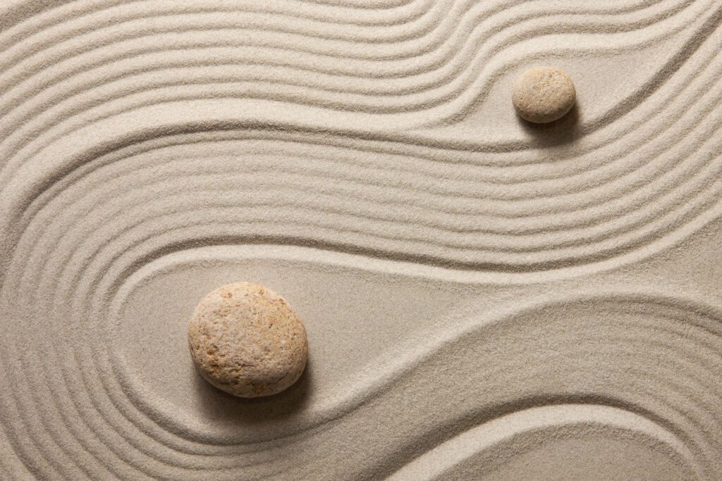 sand combed around rocks in a zen garden