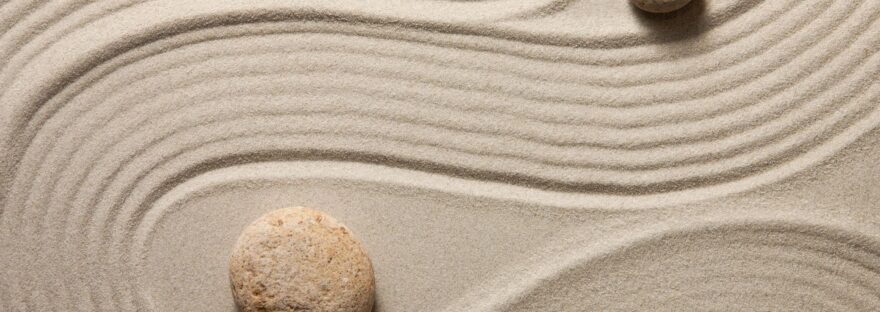 sand combed around rocks in a zen garden